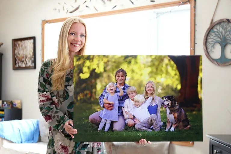 happy young woman holding canvas print family portrait blonde women large wall her children pet dog 113755035 (1)
